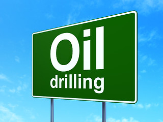 Image showing Manufacuring concept: Oil Drilling on road sign background