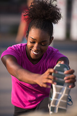 Image showing African American woman doing warming up and stretching