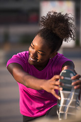 Image showing African American woman doing warming up and stretching