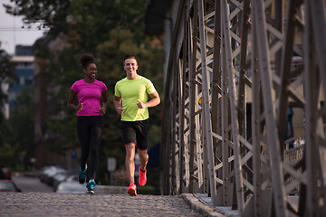 Image showing multiethnic couple jogging in the city