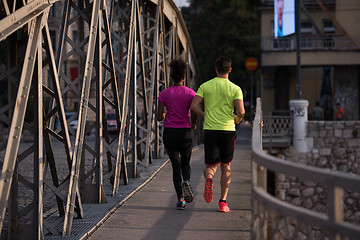 Image showing multiethnic couple jogging in the city