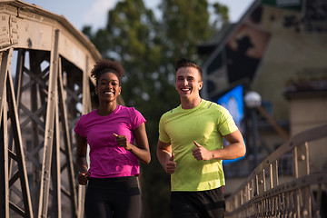 Image showing multiethnic couple jogging in the city