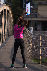 Image showing Black woman doing warming up and stretching