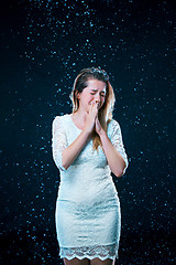 Image showing The young girl standing under running water