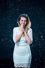 Image showing The young girl standing under running water