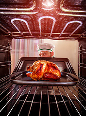 Image showing Cooking chicken in the oven.