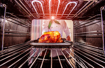 Image showing Cooking chicken in the oven.