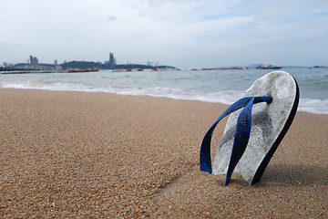 Image showing Beach slippers on a sandy beach