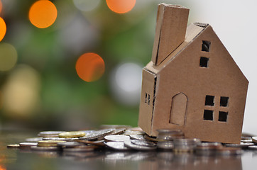 Image showing Model of house with coins on wooden table