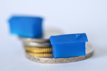 Image showing Little plastic house on metal coins