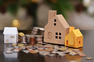 Image showing Paper house and stacks of coins standing