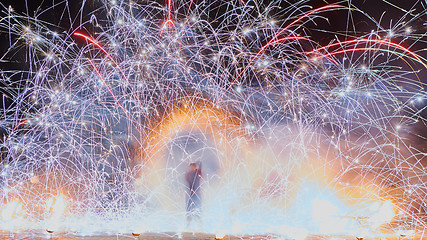 Image showing Artists juggling with burning poi\'s at fire performance.