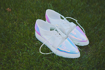 Image showing wedding bride shoes lying down on green grass