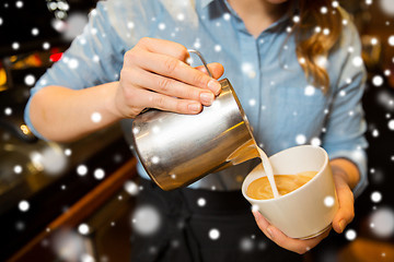 Image showing close up of woman making coffee at shop or cafe