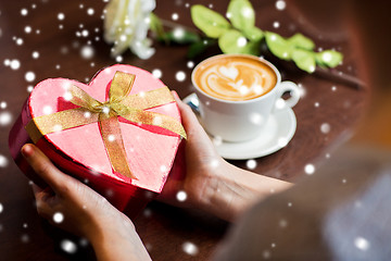 Image showing hands holding heart shaped gift box