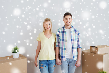 Image showing smiling couple with big boxes moving to new home