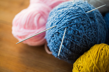 Image showing close up of knitting needles and yarn balls 