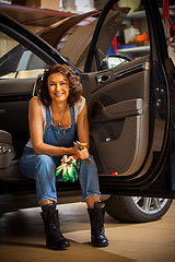 Image showing Portrait of beautiful smiling mechanic in blue overalls