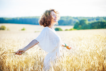 Image showing smiling happy woman in wheat field