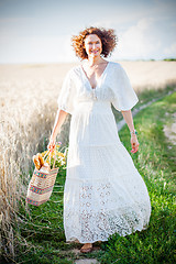 Image showing Pretty smiling Woman Outdoors with wicker bag with natural meal 