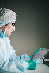 Image showing Side view of scientist working on tablet