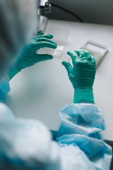 Image showing Crop hands putting microscope glasses in box