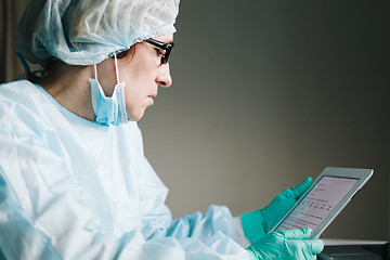 Image showing Side view of scientist working on tablet