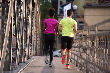 Image showing multiethnic couple jogging in the city