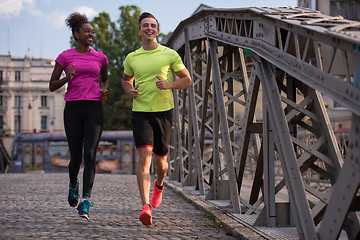 Image showing multiethnic couple jogging in the city