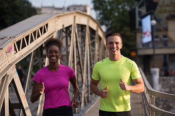 Image showing multiethnic couple jogging in the city