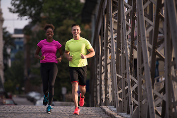 Image showing multiethnic couple jogging in the city