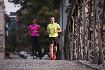 Image showing multiethnic couple jogging in the city