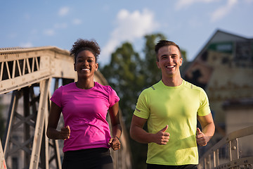 Image showing multiethnic couple jogging in the city