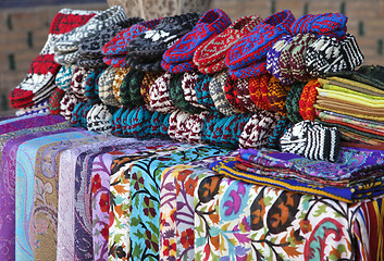 Image showing Scarves and knitted slippers in a street market, Uzbekistan