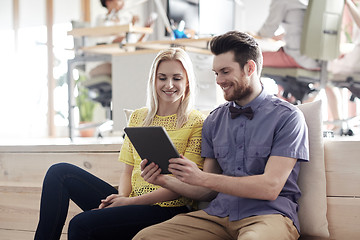 Image showing happy creative team with tablet pc in office