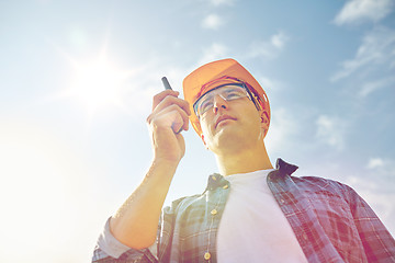 Image showing builder in hardhat with walkie talkie