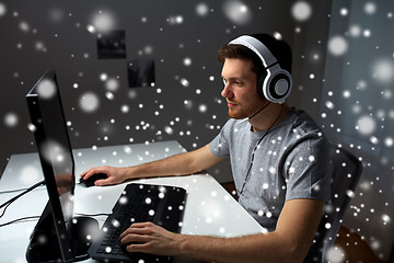 Image showing man in headset playing computer video game at home