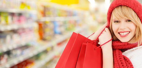 Image showing woman in hat and scarf shopping at supermarket