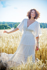 Image showing beautiful middle-aged woman dressed in white fashionable dress