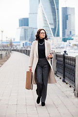 Image showing Beautiful middle-aged woman in a bright coat