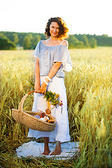 Image showing Beautiful middle-aged woman standing in a wheat field