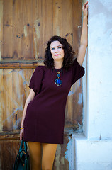 Image showing beautiful woman in a fashionable burgundy dress