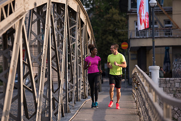 Image showing multiethnic couple jogging in the city