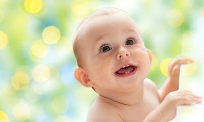 Image showing happy little baby boy or girl looking up