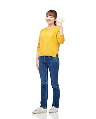 Image showing happy asian young woman showing ok hand sign