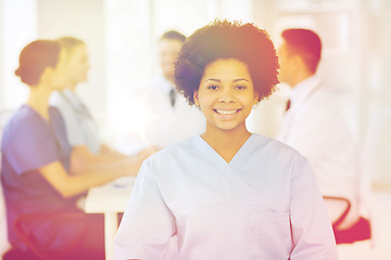 Image showing happy doctor over group of medics at hospital