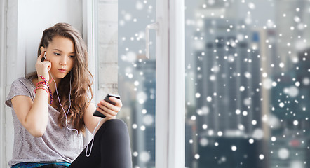 Image showing teenage girl with smartphone and earphones