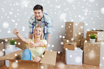 Image showing happy couple having fun with boxes at new home