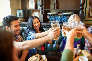 Image showing happy friends drinking beer at bar or pub