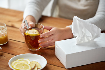 Image showing close up of ill woman drinking tea with lemon